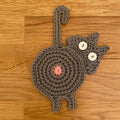 Niedliche gestrickte Kätzchen-Hintern-Untersetzer